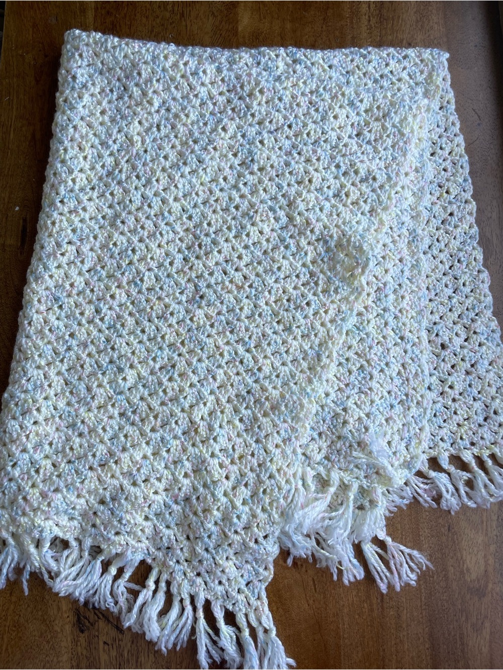 hand knit crochet baby blanket neutral colors yellow pink and blue with fringe